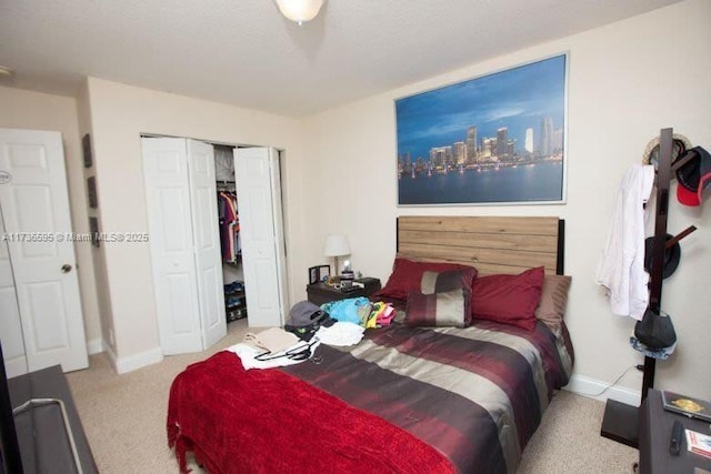 bedroom featuring light colored carpet and a closet