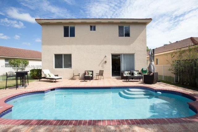 back of house featuring a fenced in pool and a patio