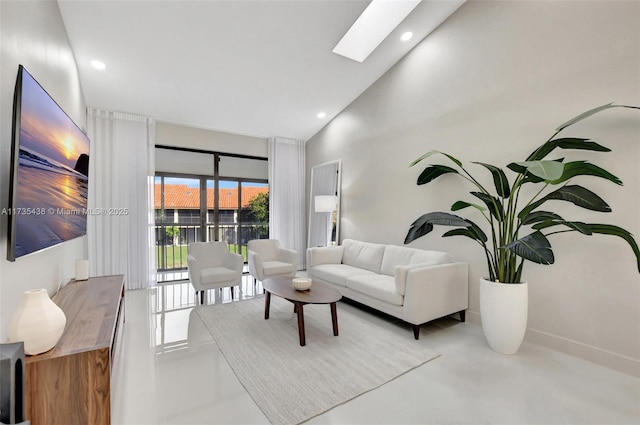 living room with a skylight and high vaulted ceiling