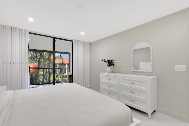 bedroom with a wall of windows and access to outside