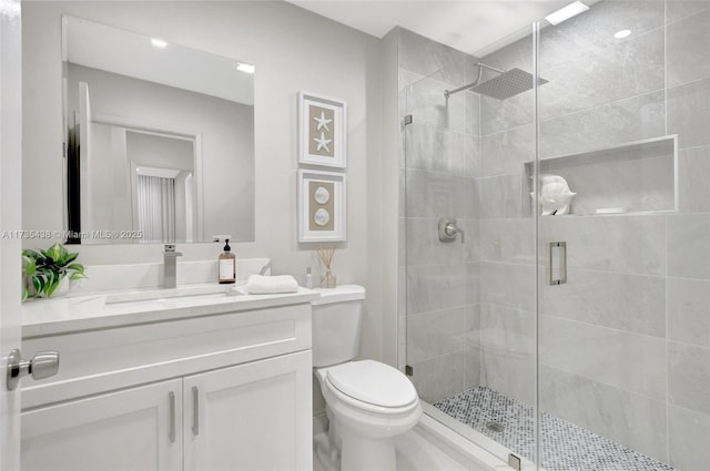 bathroom featuring vanity, toilet, and walk in shower