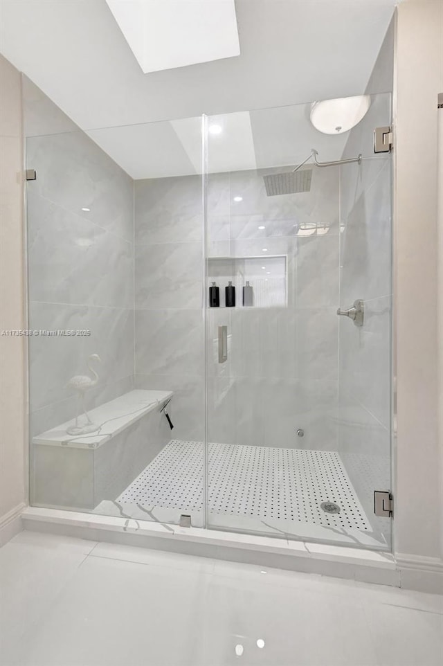 bathroom featuring tile patterned floors and a shower with door