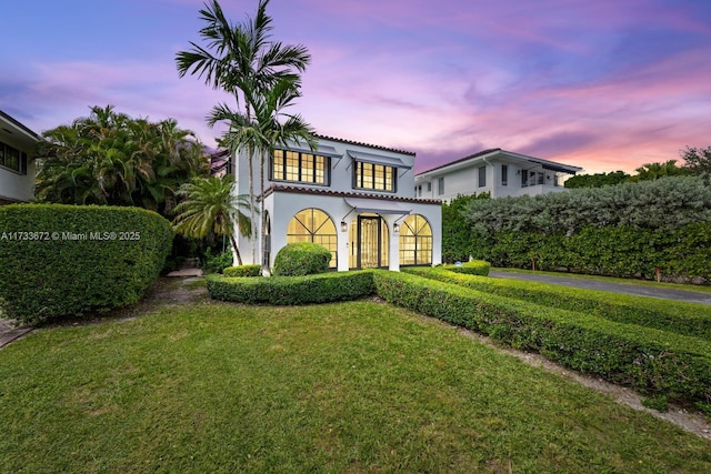 mediterranean / spanish-style home featuring a yard