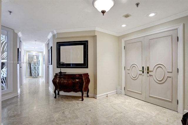 foyer entrance with marble finish floor, baseboards, visible vents, and ornamental molding