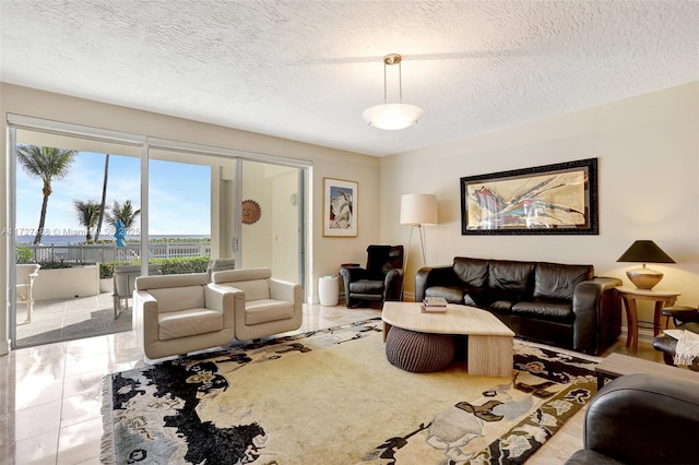 living room featuring light tile patterned flooring and a textured ceiling