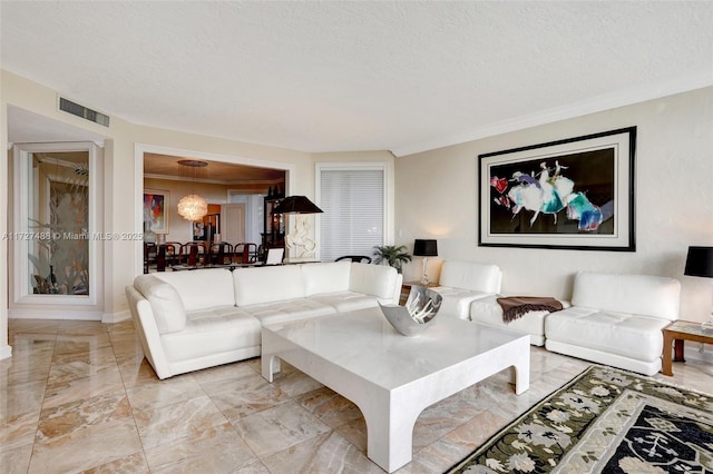 living room featuring marble finish floor, visible vents, crown molding, and a textured ceiling