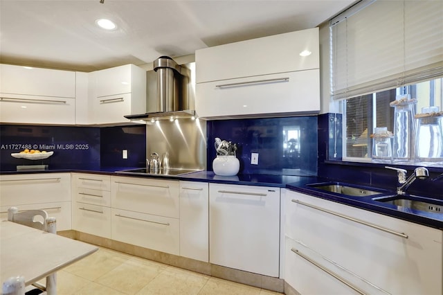 kitchen with white cabinetry, light tile patterned floors, and backsplash