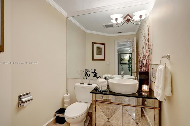 bathroom featuring vanity, crown molding, and toilet