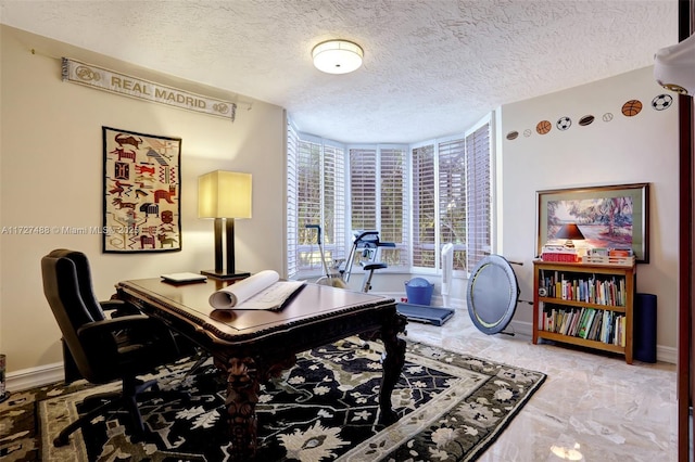 office with marble finish floor, a textured ceiling, and baseboards