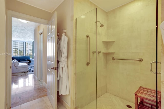 bathroom with a shower stall and tile patterned floors