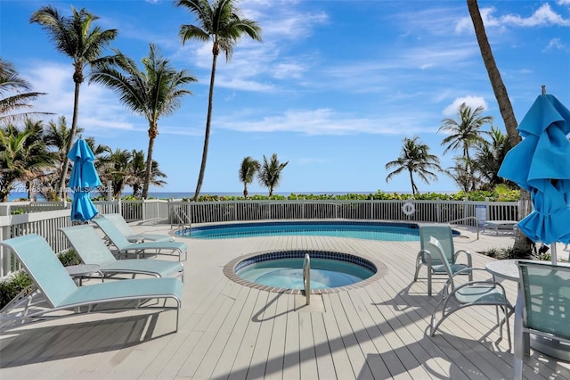 view of swimming pool featuring a hot tub