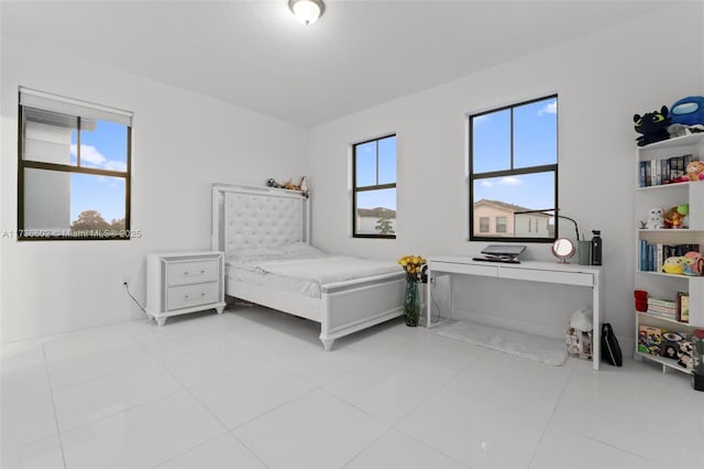 tiled bedroom featuring multiple windows