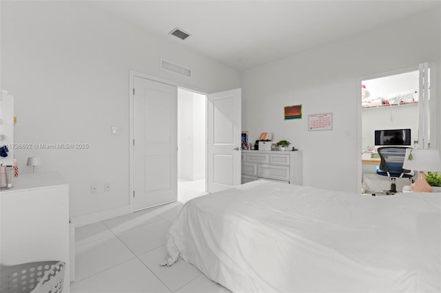 bedroom with light tile patterned floors