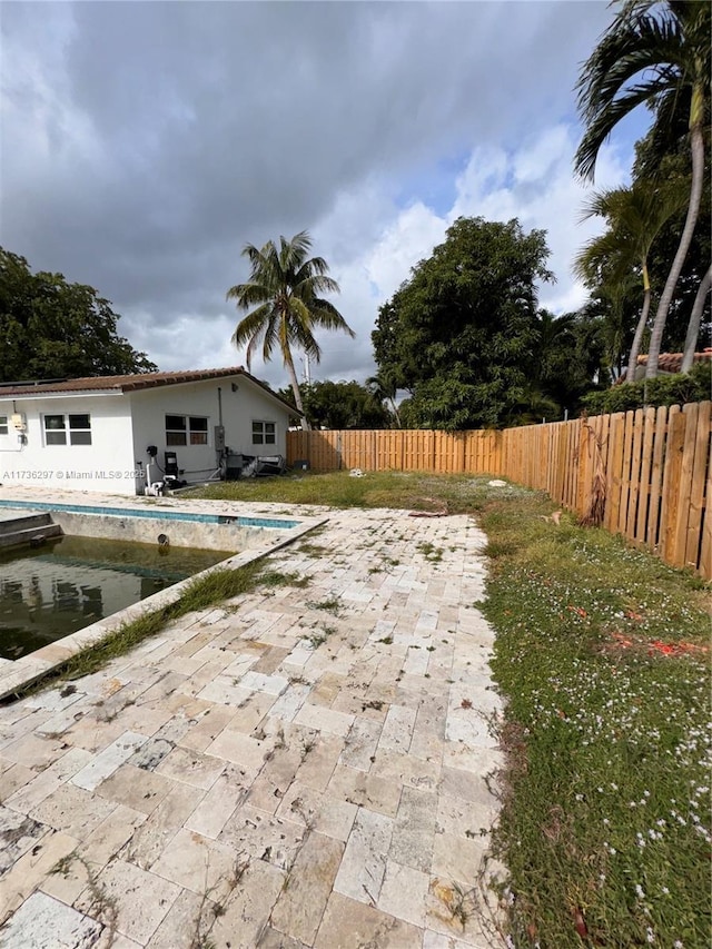 view of patio with a fenced in pool