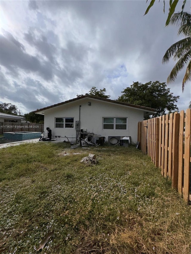 view of property exterior with a lawn