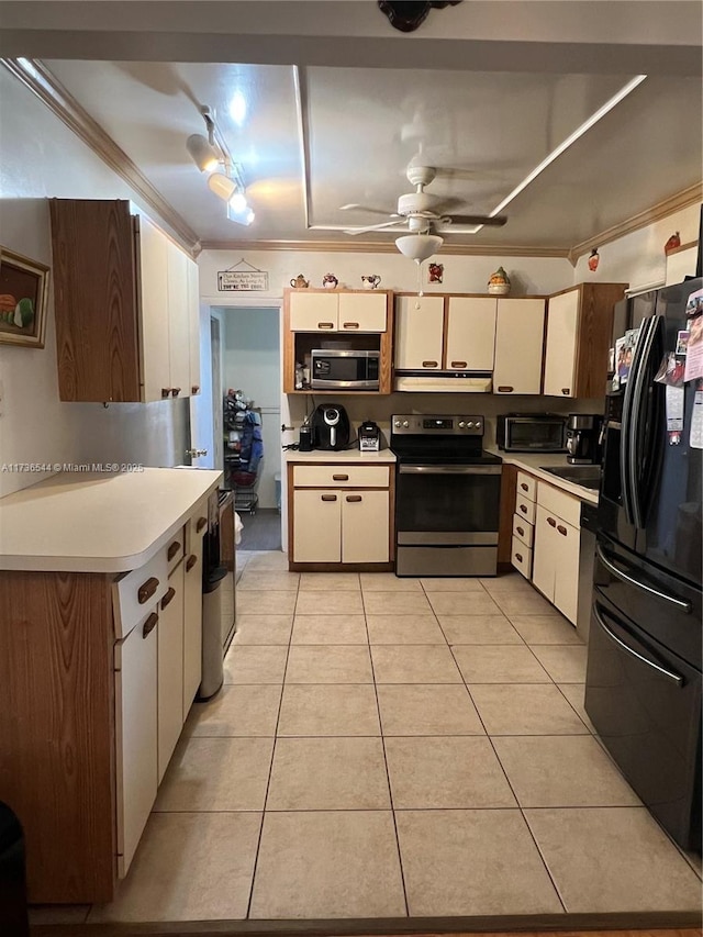 kitchen with appliances with stainless steel finishes, ornamental molding, light countertops, under cabinet range hood, and light tile patterned flooring