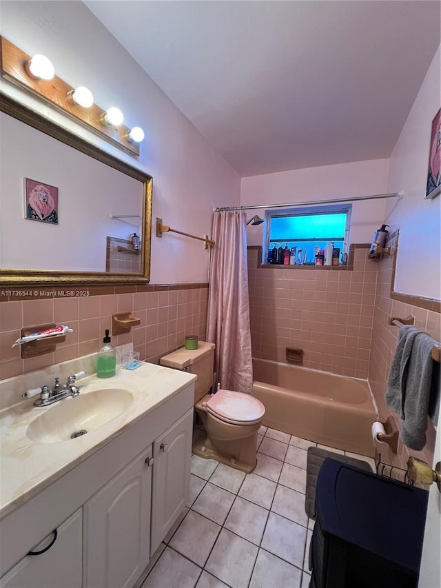 bathroom featuring tile walls, toilet, shower / bath combo, vanity, and tile patterned floors