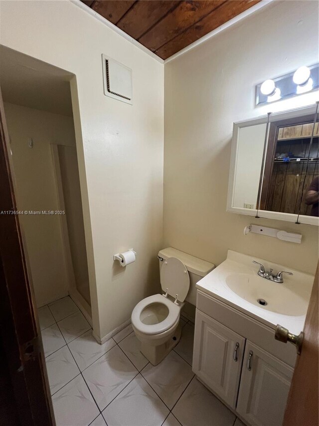 bathroom with walk in shower, tile patterned floors, vanity, and toilet