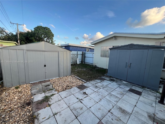 view of shed featuring fence