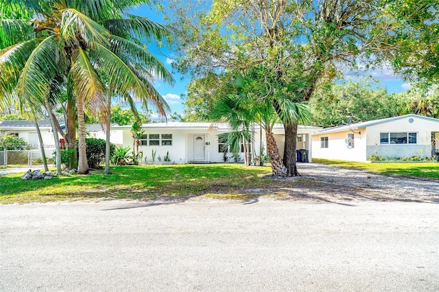 ranch-style home featuring a front yard