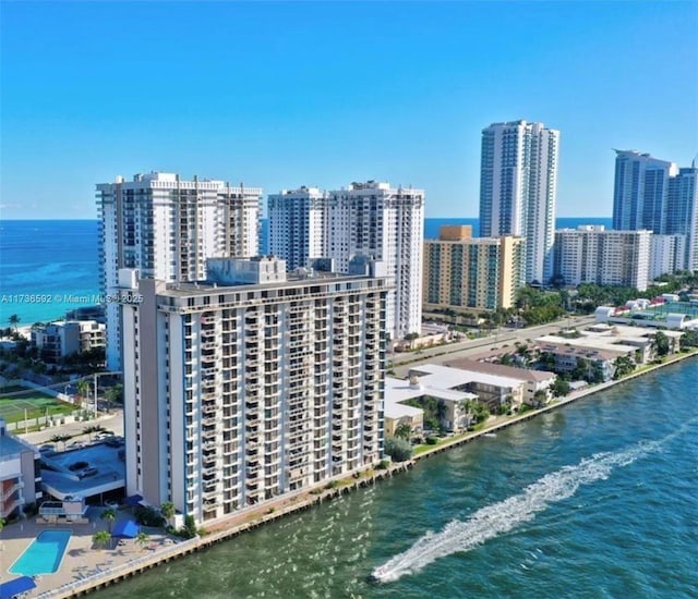 birds eye view of property with a city view and a water view