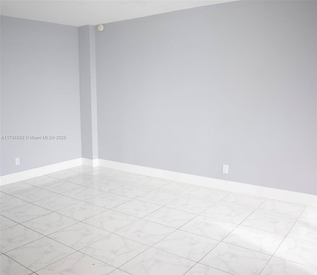 empty room featuring baseboards