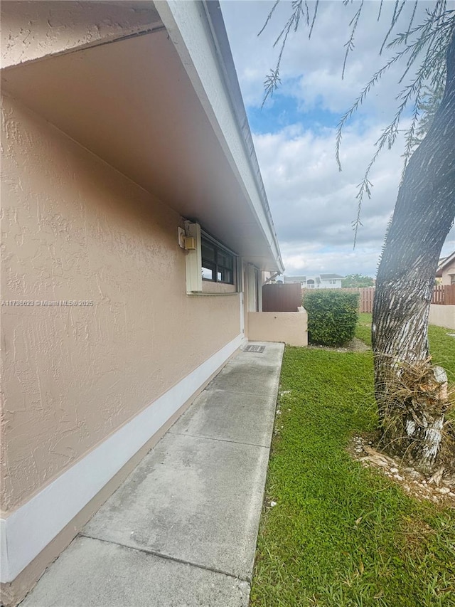 view of side of property with a lawn