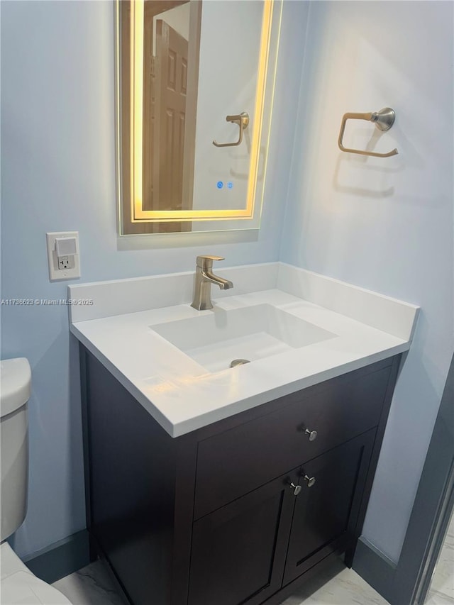 bathroom featuring vanity and toilet