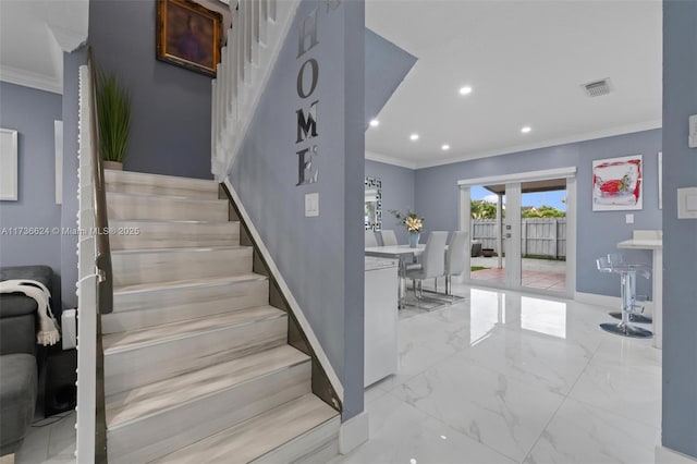 stairs featuring french doors and crown molding