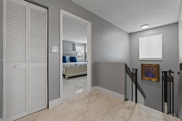 corridor with a textured ceiling