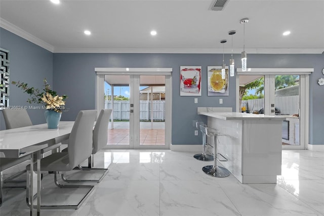 interior space with plenty of natural light, ornamental molding, and french doors