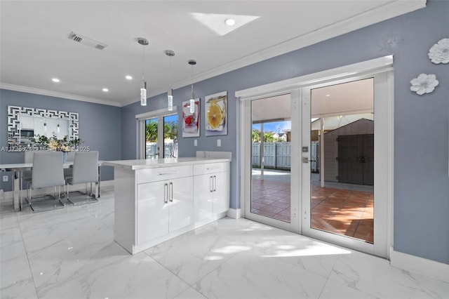 kitchen featuring hanging light fixtures, crown molding, french doors, and white cabinets