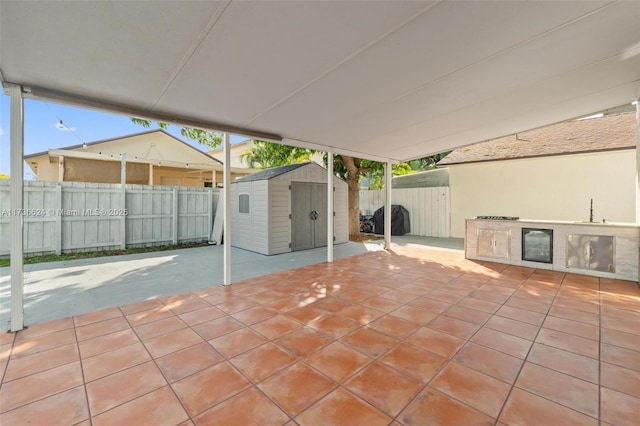 view of patio / terrace featuring a grill and a storage unit