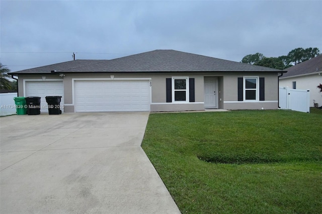 single story home featuring a garage and a front lawn