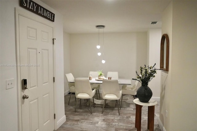 dining area with hardwood / wood-style floors