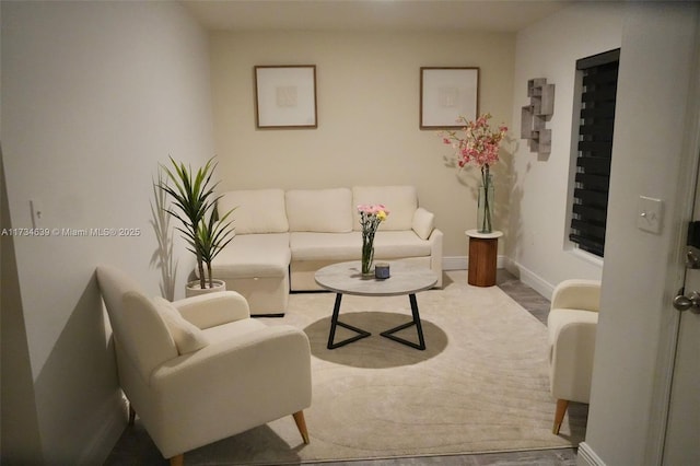 living area with wood finished floors and baseboards