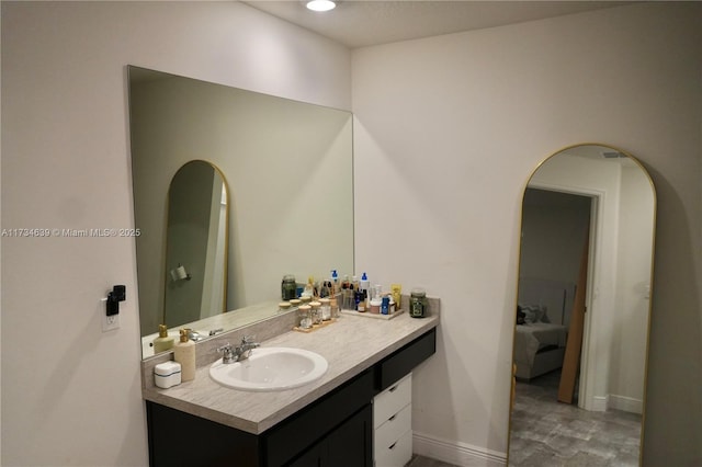 bathroom featuring baseboards and vanity