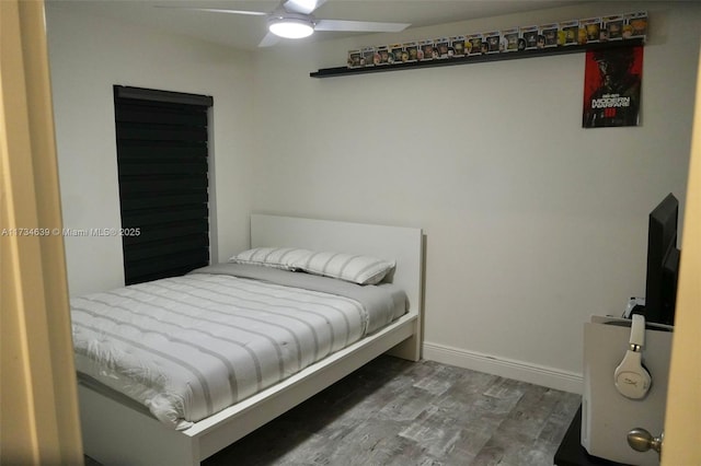 bedroom with wood finished floors, baseboards, and ceiling fan
