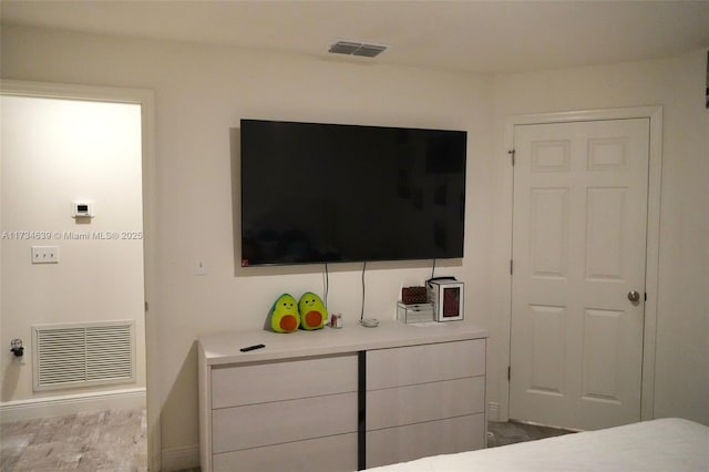bedroom featuring visible vents and baseboards