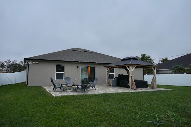 back of property with a gazebo, a yard, a patio, and an outdoor fire pit