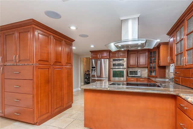 kitchen featuring stainless steel appliances, decorative backsplash, and island range hood