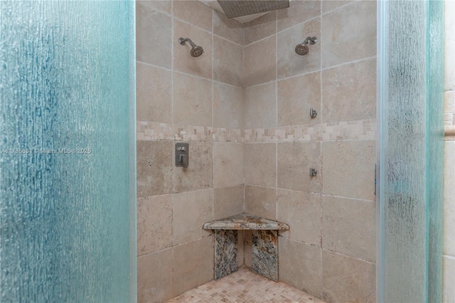 bathroom with a tile shower