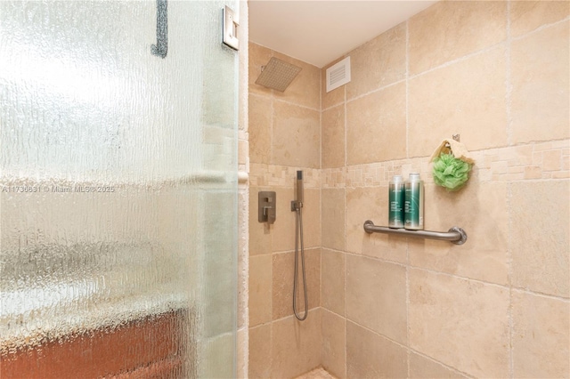 bathroom with a tile shower