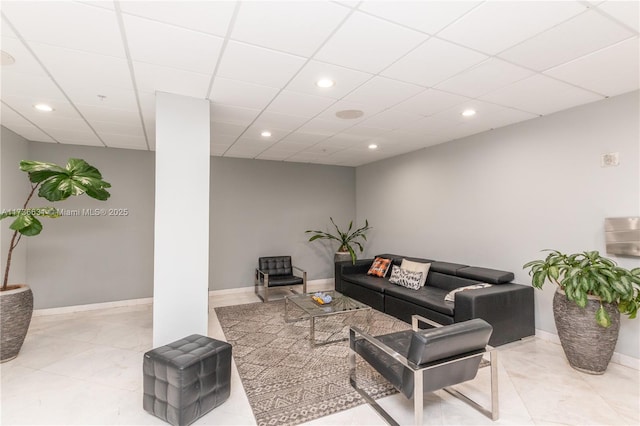 living room featuring a drop ceiling