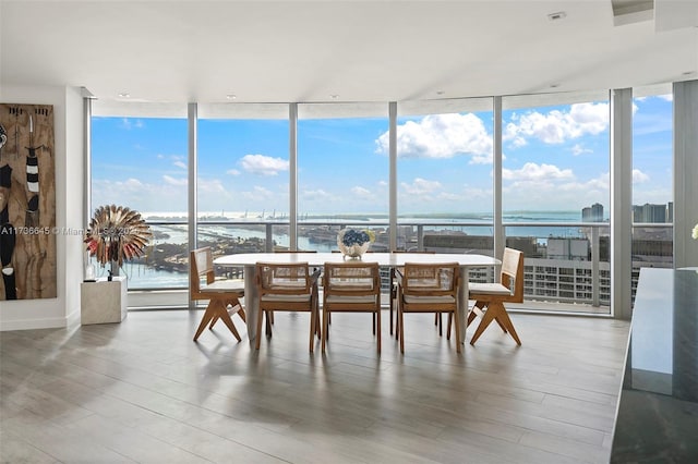 sunroom / solarium featuring a water view