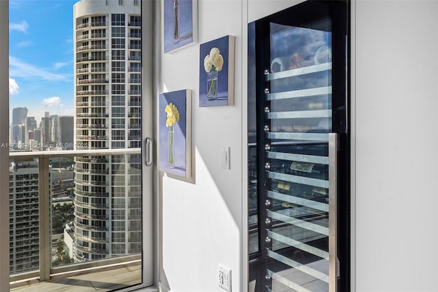 entrance to property with beverage cooler and a balcony