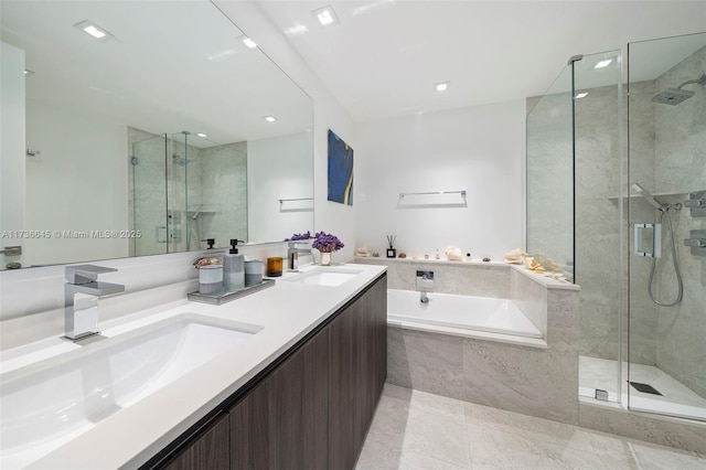 bathroom with vanity and separate shower and tub