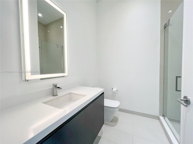 bathroom featuring vanity, toilet, tile patterned floors, and a shower with shower door