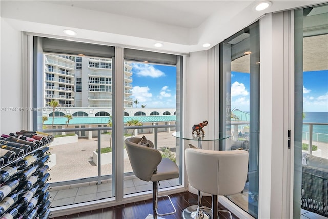 dining room featuring a water view and dark hardwood / wood-style floors