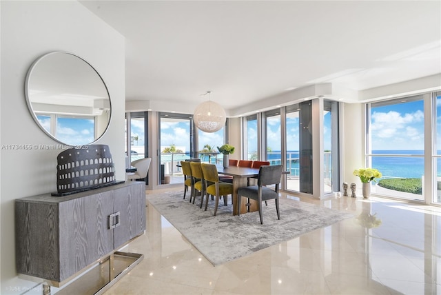 dining area with a wall of windows and a water view